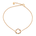 18k gold bracelet with a pavé floral circle charm on a white background