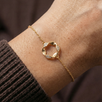 Floral charm bracelet worn on the wrist