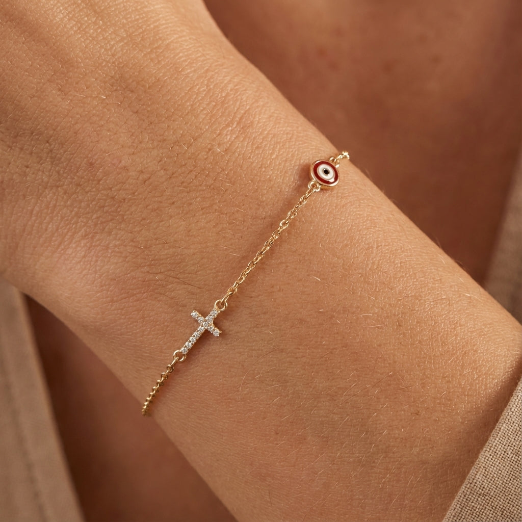 Evil eye and cross charm bracelet worn on the wrist