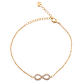 18k gold infinity charm bracelet on a white background