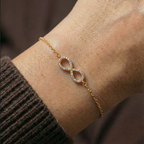 Infinity charm bracelet worn on the wrist