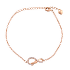 Gold-plated infinity bracelet with pavé and polished finish on a white background