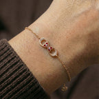 Infinity charm bracelet with evil eye accents worn on wrist