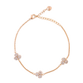 Gold-plated bracelet with pavé flower cluster accents on a white background