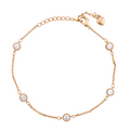Gold-plated bracelet with round bezel-set stone accents on a white background