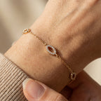 Minimal gold bracelet with marquise pavé links worn on wrist