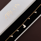 Gold heart charm bracelet displayed in Zircon Jewels gift box