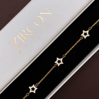 Gold star charm bracelet displayed in Zircon Jewels gift box