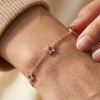 Gold-plated star bracelet worn on wrist