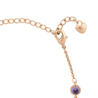Fine gold bracelet chain detail on a white background