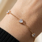Gold heart stone bracelet worn on wrist