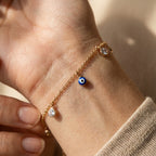 Gold-plated evil eye bracelet worn on wrist