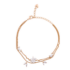 18K gold-plated layered floral bracelet with marquise stones on a white background
