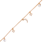 Close-up of crescent moon and star charms on gold chain bracelet on a white background