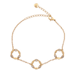 Gold bracelet with circular links on a white background