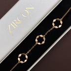 Gold bracelet with circular designs on a Zircon box