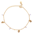 18k Gold bracelet with charms on a white background