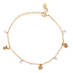 18k Gold bracelet with charms on a white background