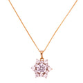 Gold-plated floral cluster pendant necklace with clear stones on a white background