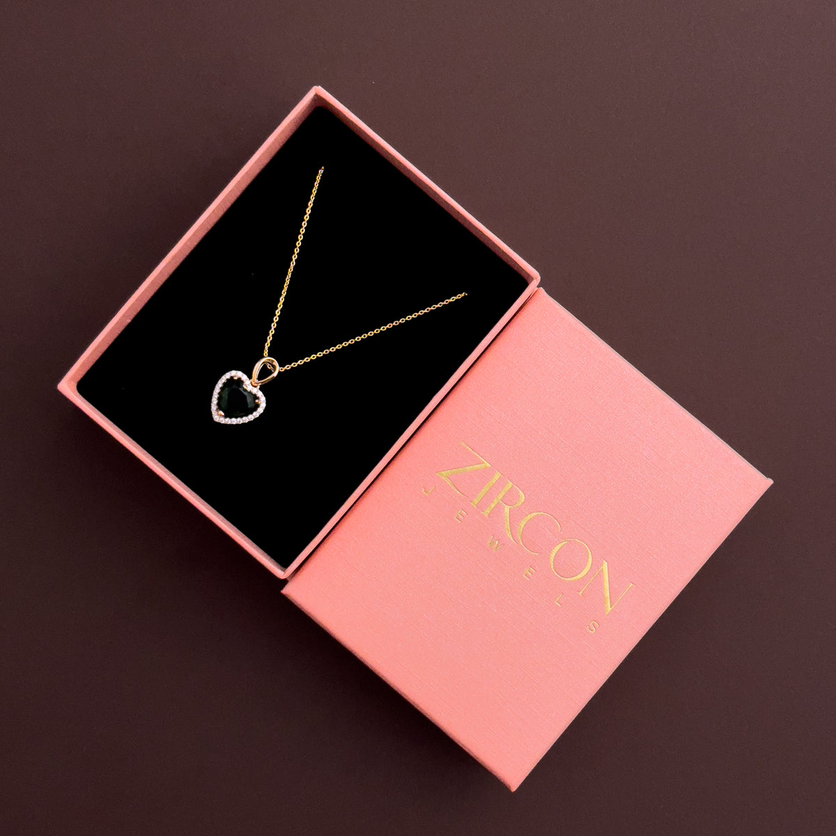 Emerald-green heart halo pendant necklace in a Zircon Jewels gift box