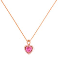 Gold-plated necklace with a heart-shaped pink gemstone pendant on a white background