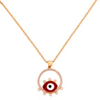 Gold-plated evil eye pendant necklace with red enamel and pavé halo on a white background