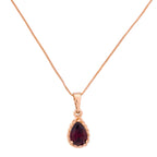 Gold-plated teardrop pendant necklace with a deep red stone on a white background