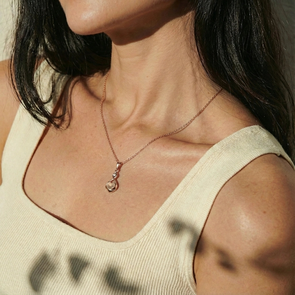 Infinity-heart pendant necklace worn on the neck