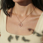 Open heart pendant necklace worn on the neck