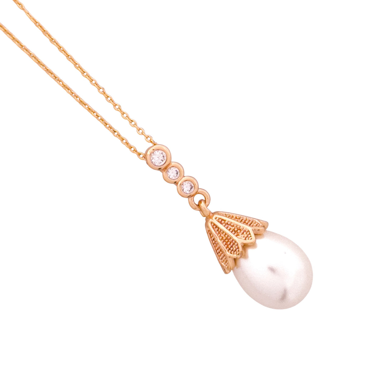 Close-up of the teardrop pearl pendant and textured cap