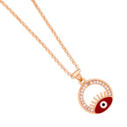 Close-up of the red evil eye pendant and pavé circle frame