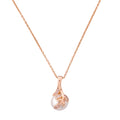 Gold-plated leaf pendant necklace with a pearl drop on a white background
