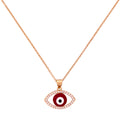 Gold-plated red evil eye pendant necklace with a pavé border on a white background