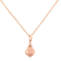 18k gold necklace with a teardrop pendant and textured center on a white background