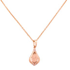 18k gold necklace with a teardrop pendant and textured center on a white background