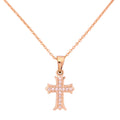 18k gold cross pendant necklace with pavé detailing on a white background