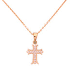 18k gold cross pendant necklace with pavé detailing on a white background