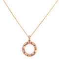 Gold necklace with a circular pendant on a white background