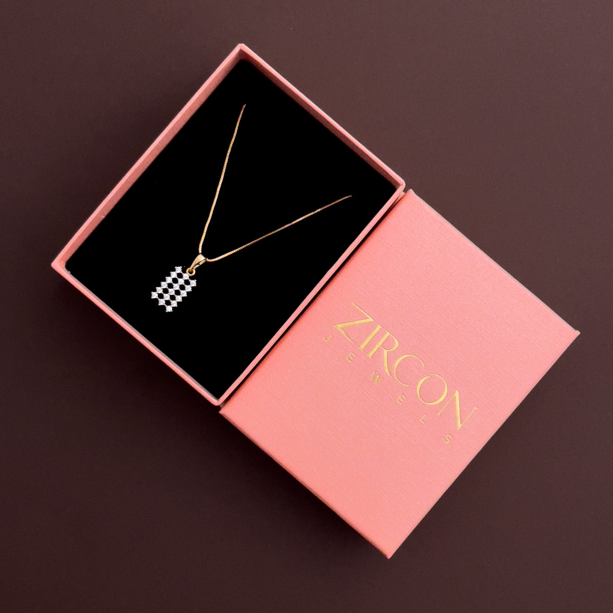 Zircon Lattice Glow rectangular pavé pendant necklace placed inside a blush pink Zircon gift box